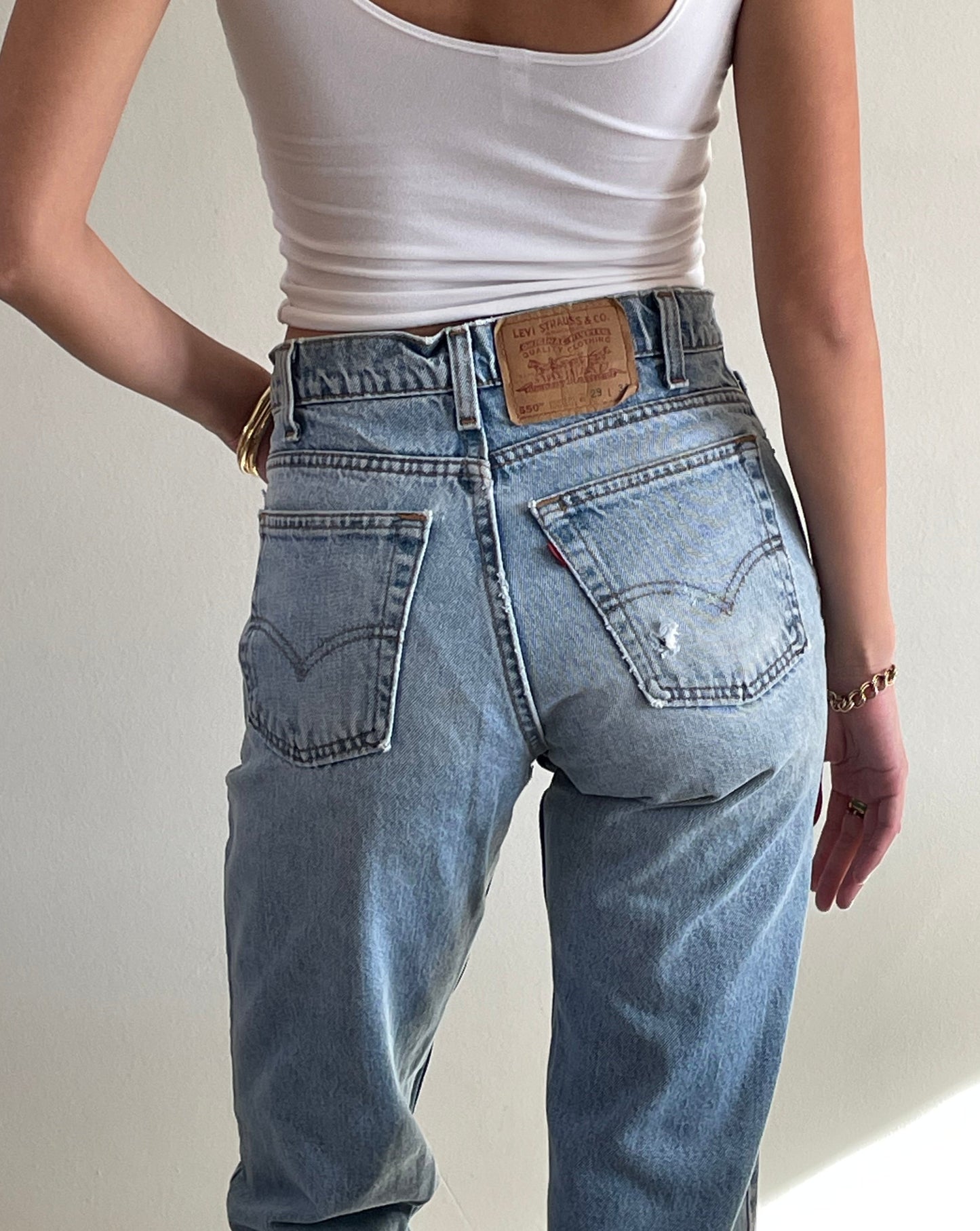 vintage Levi's 550 high waisted faded light wash zipper tall Levis jeans made in USA size 28