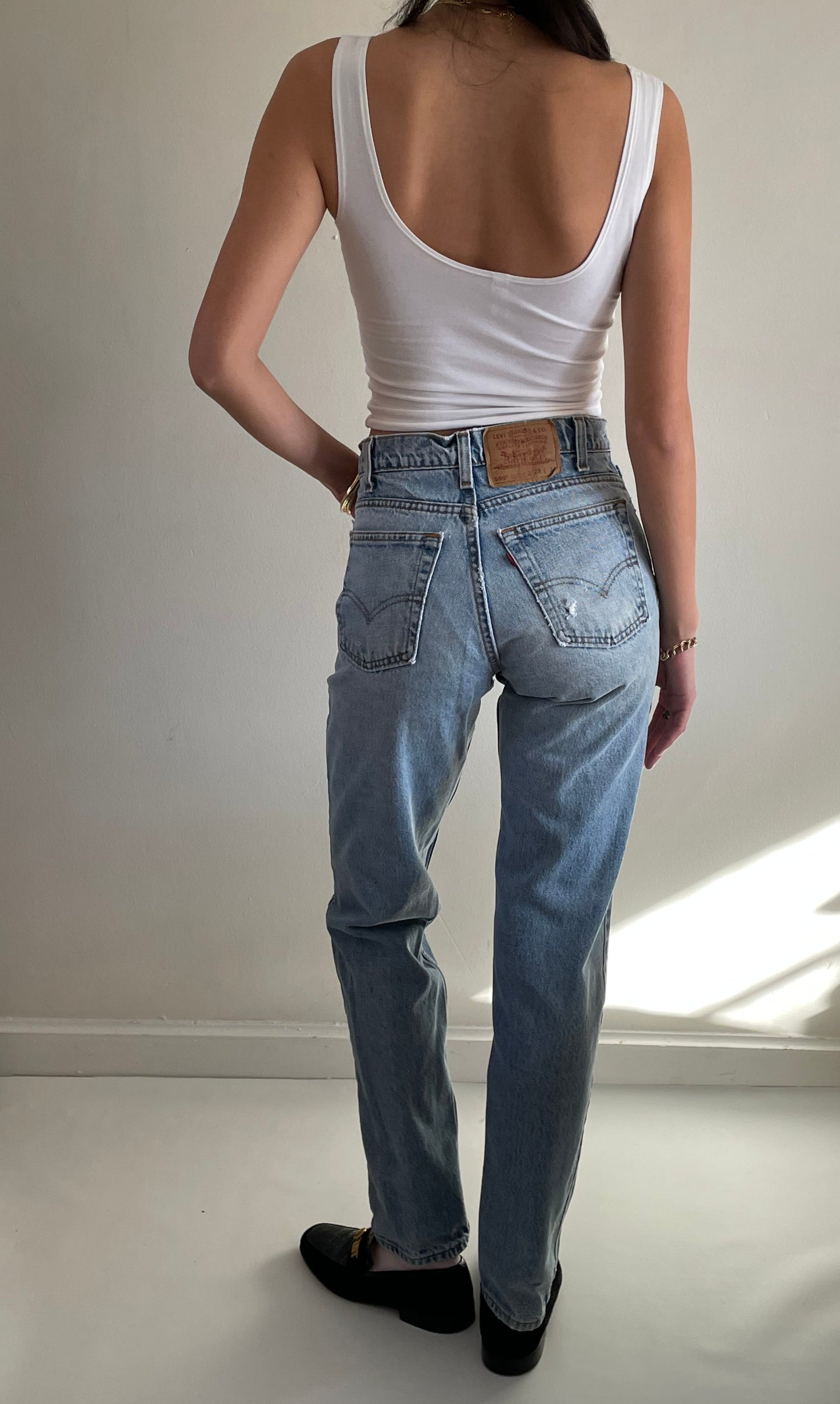 vintage Levi's 550 high waisted faded light wash zipper tall Levis jeans made in USA size 28